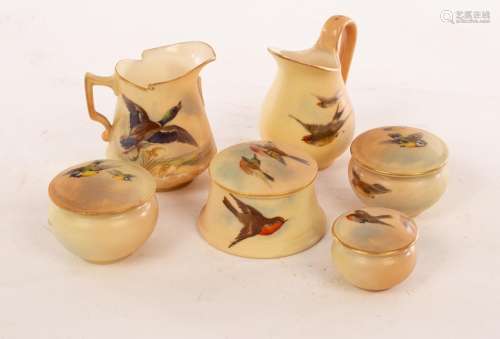 Four Royal Worcester miniature lidded boxes of circular form...