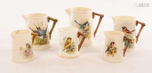 Six Royal Worcester ribbed jugs painted birds, four signed W...