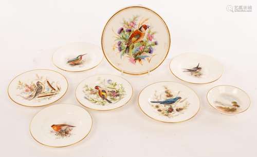 A Royal Worcester circular tea pot stand painted a chaffinch...