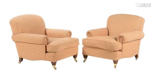 A pair of upholstered armchairs in the manner of George Smit...