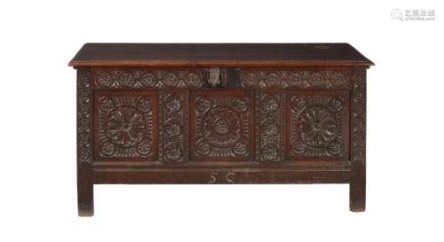 A carved oak three panelled coffer