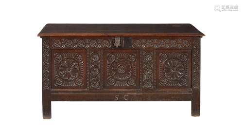 A carved oak three panelled coffer