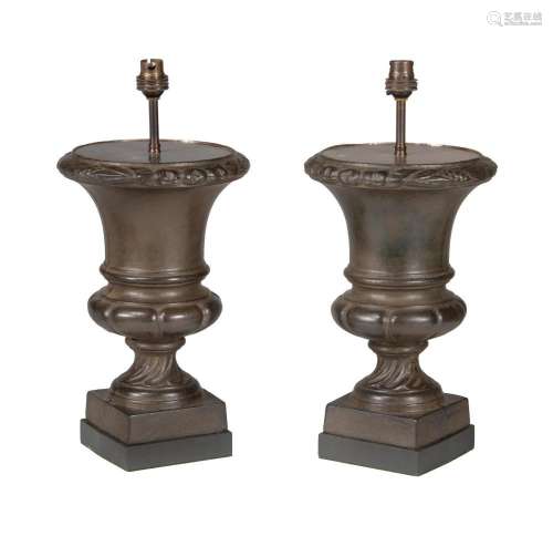 A pair of French bronze patinated cast iron urns