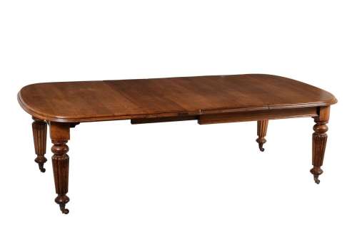 A Victorian oak extending dining table