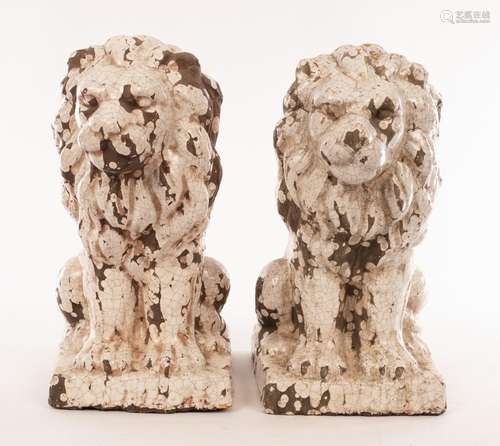 A pair of modern glazed terracotta lions, with craquelure ef...