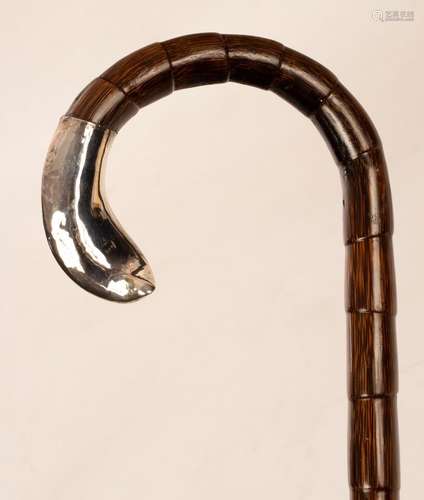 A gentlemans walking cane with silver mount,