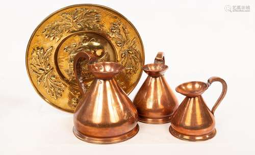 A graduated set of three copper measures, half gallon to pin...