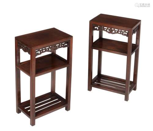 A pair of Chinese hardwood three tier occasional tables or s...