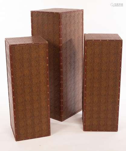 Three modern plinths in faux crocodile skin with studded bor...