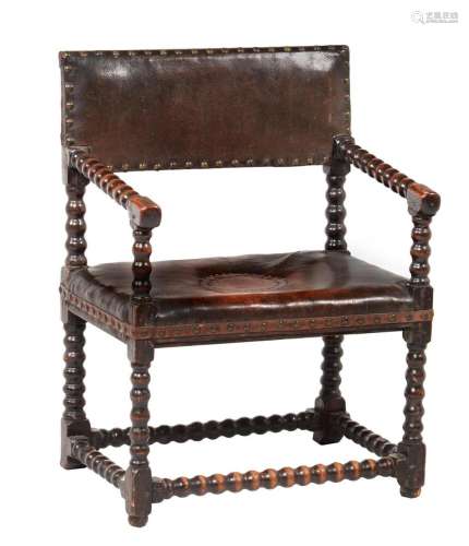 An oak and leather upholstered armchair
