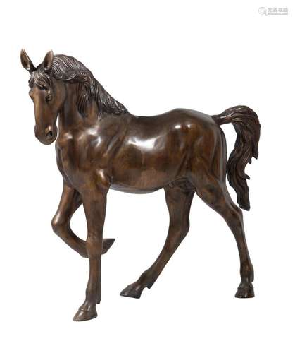 A bronzed metal figure of a horse