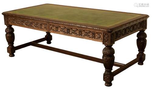 A late Victorian carved oak partners writing table,