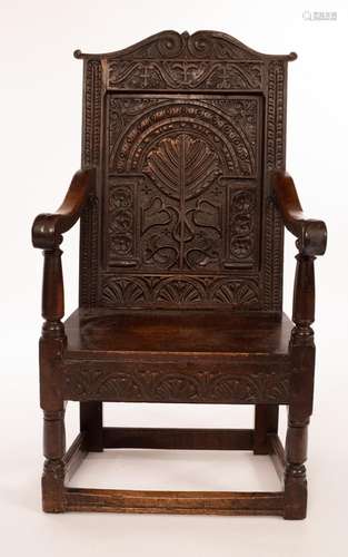 A Charles I walnut and oak wainscot chair, the arch panel ba...