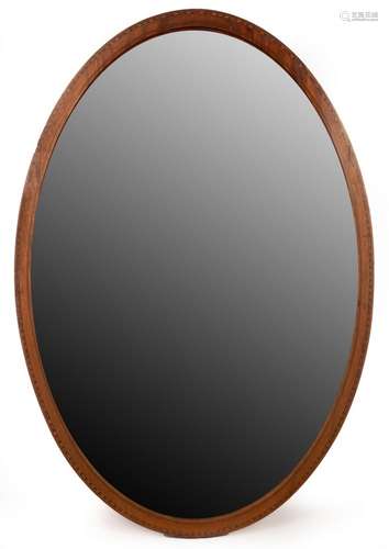 An Edwardian mahogany oval wall mirror with chequered border...