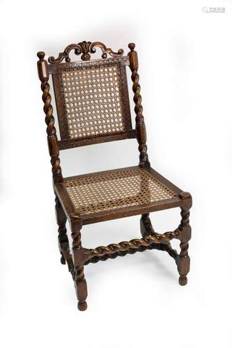 A Charles II walnut cane back side chair with scroll carved ...