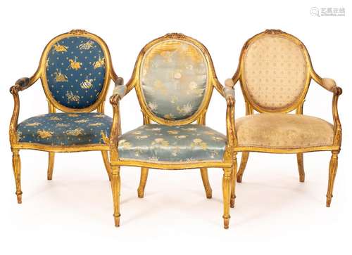 A set of three George III giltwood open armchairs,