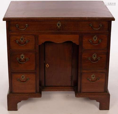 A Georgian mahogany kneehole desk, with eight drawers and kn...