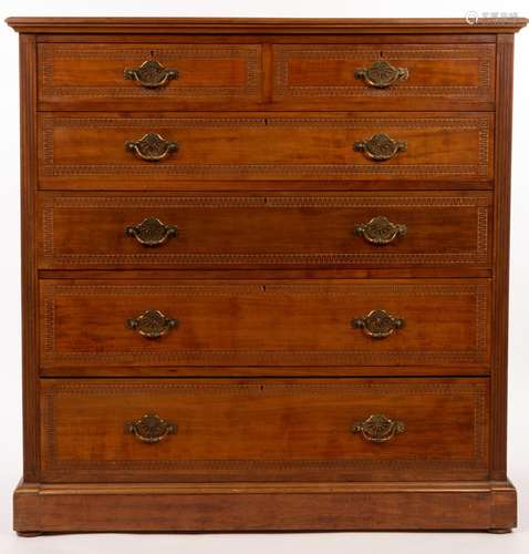 An Edwardian walnut chest of two short over four long drawer...