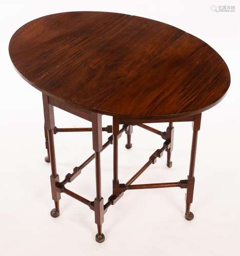 An oval two-flap table on turned legs with pad feet, 60.