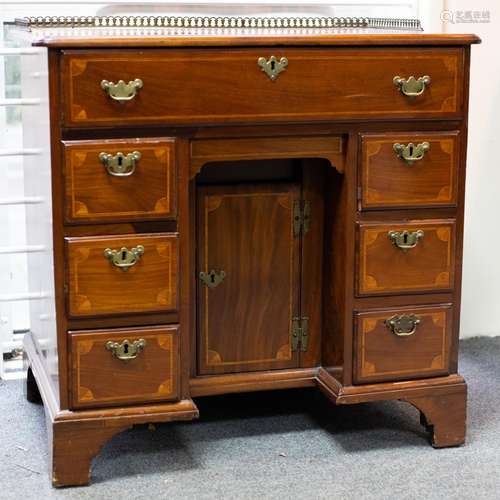 A George III mahogany and inlaid kneehole desk the top with ...