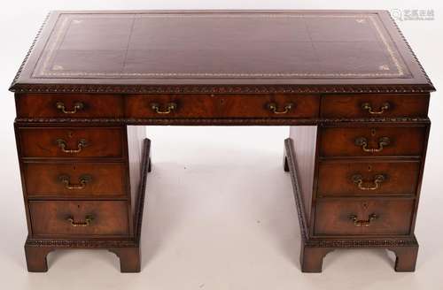 A George III style mahogany pedestal desk with leather lined...