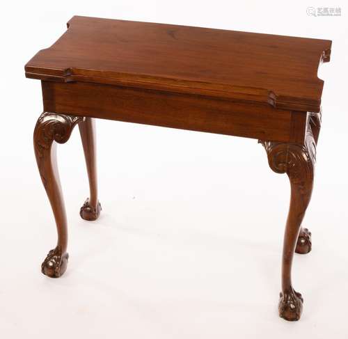 A Georgian mahogany tea table with shaped top and claw and b...