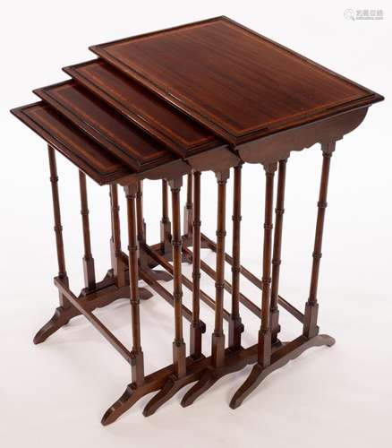 A nest of four mahogany tables banded in satinwood, on twin ...