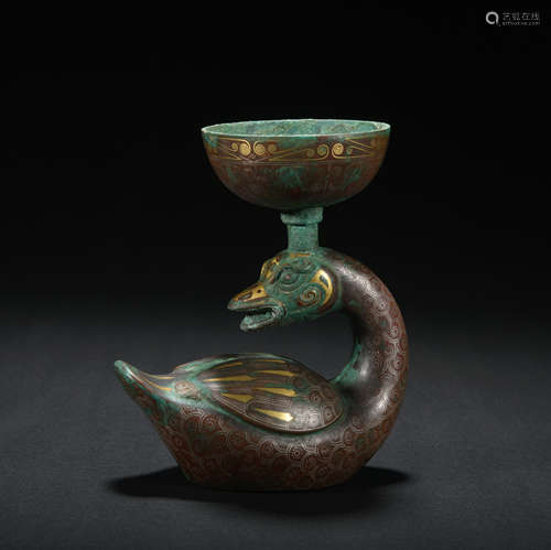 A bronze candlestick ware with gold and silver