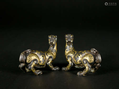 A pair of bronze beast ware with gold and silver