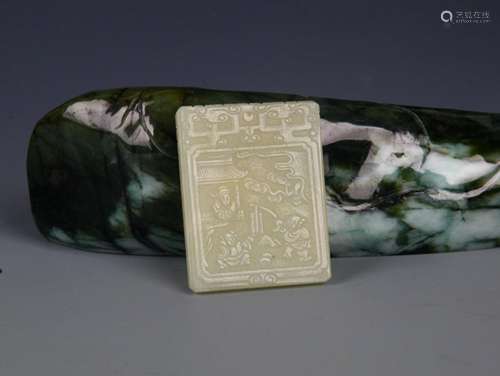 A FINELY CARVED HETIAN PALE CELADON JADE PENDANT