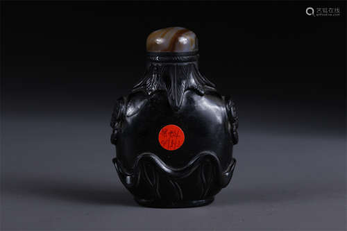 A Glass Snuff Bottle with Beast Face Design.