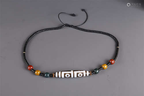 A Necklace of Four-Eye Dzi Bead.