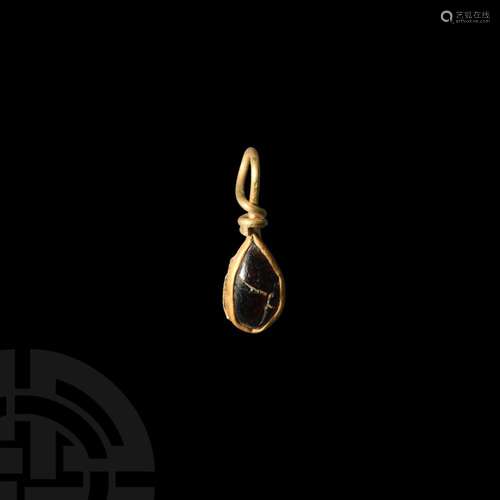 Migration Period Gold Pendant with Garnet