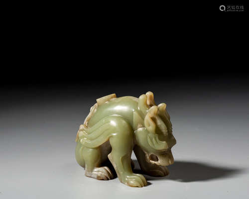 A CELADON AND RUSSET JADE CARVING OF A MYTHICAL BEAST