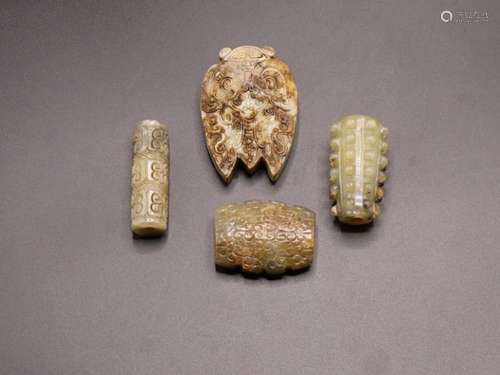 FOUR CHINESE ARCHAIC STYLE JADE PENDANTS