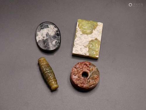 FOUR CHINESE ARCHAIC STYLE JADE PENDANTS