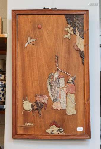 An early 20th century Oriental panel inset with carved hards...