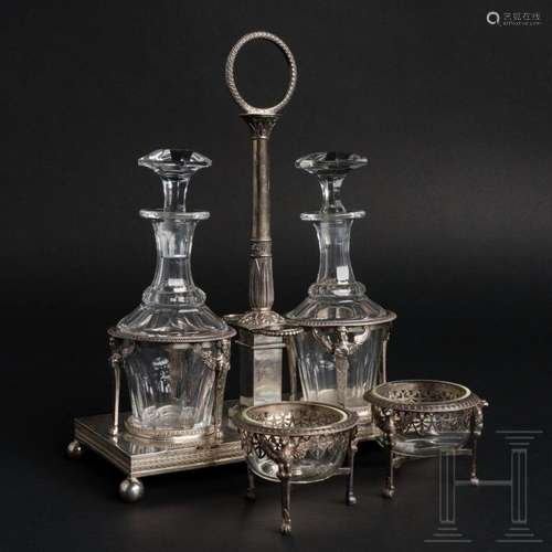 A French silver ménage with two glass carafes and a pair of ...