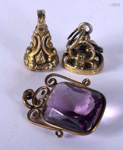 TWO FOBS and a pendant. 10.8 grams. Largest 3 cm x 2 cm. (3)