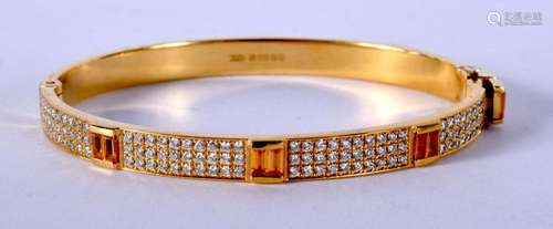 AN 18CT GOLD AND DIAMOND BANGLE. 29.4 grams. 6 cm wide.