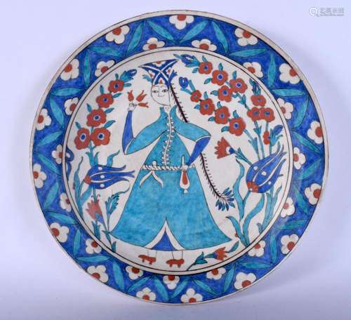 A TURKISH MIDDLE EASTERN IZNIK PLATE painted with a female. ...