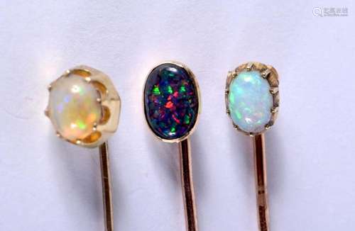 THREE YELLOW METAL AND OPAL PINS. 4.2 grams. Largest 6 cm lo...