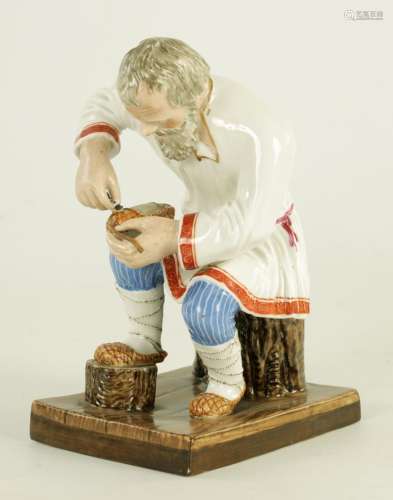 AN EARLY 20TH CENTURY RUSSIAN PORCELAIN FIGURE DEPICTING A C...