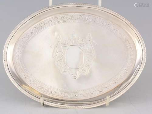 A GEORGE III OVAL BRIGHT CUT ENGRAVED SILVER TEAPOT STAND