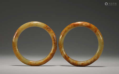 A pair of red jade bracelets