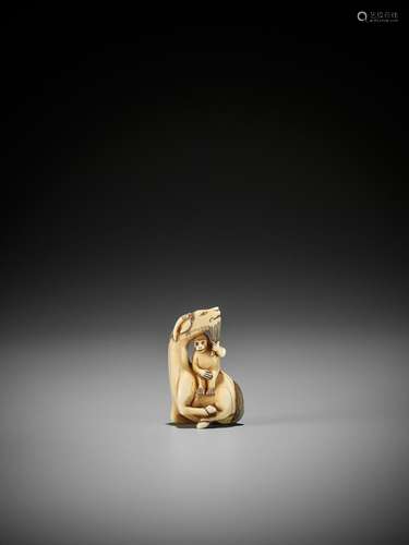 AN IVORY NETSUKE OF A SINIU AND MONKEY