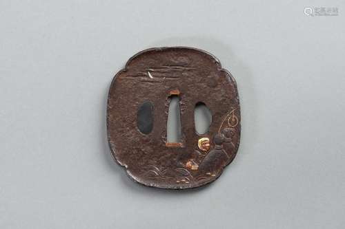 AN INLAID IRON TSUBA WITH A MAN TRYING TO CATCH A FOX