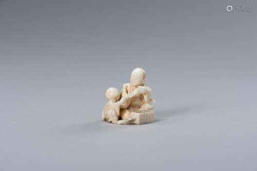 A MINIATURE IVORY OKIMONO OF FATHER AND CHILD