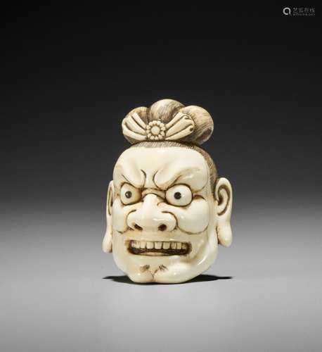 A FINE IVORY NETSUKE OF A SEVERED NIO HEAD