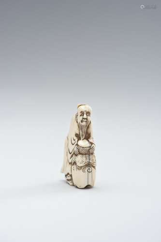 AN IVORY NETSUKE OF A CHINESE SAGE